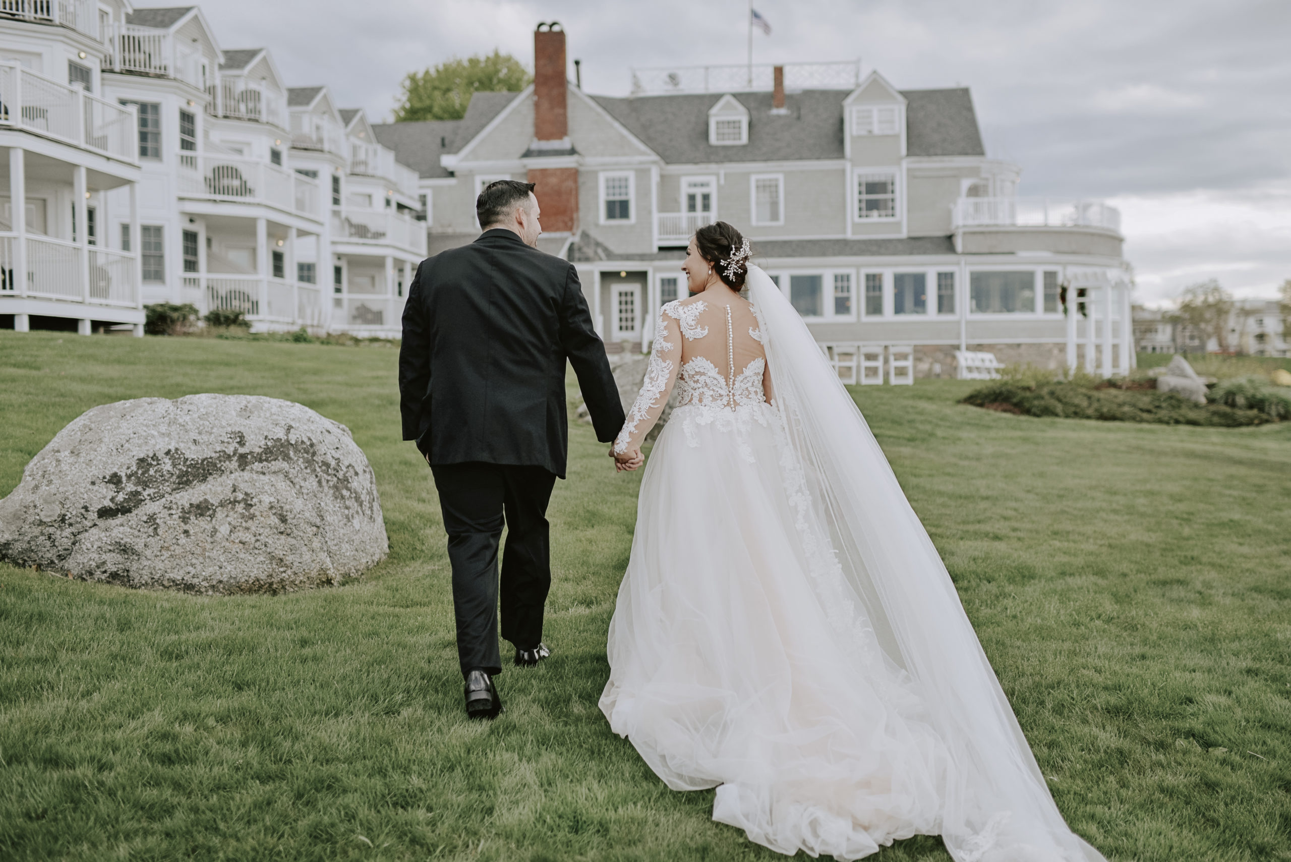 Photo of the bride and groom walking toward the Bar Harbor Inn