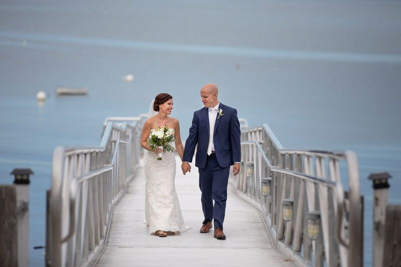 Photo of a bride and groom walking up the dock at the Atlantic Oceanside Hotel