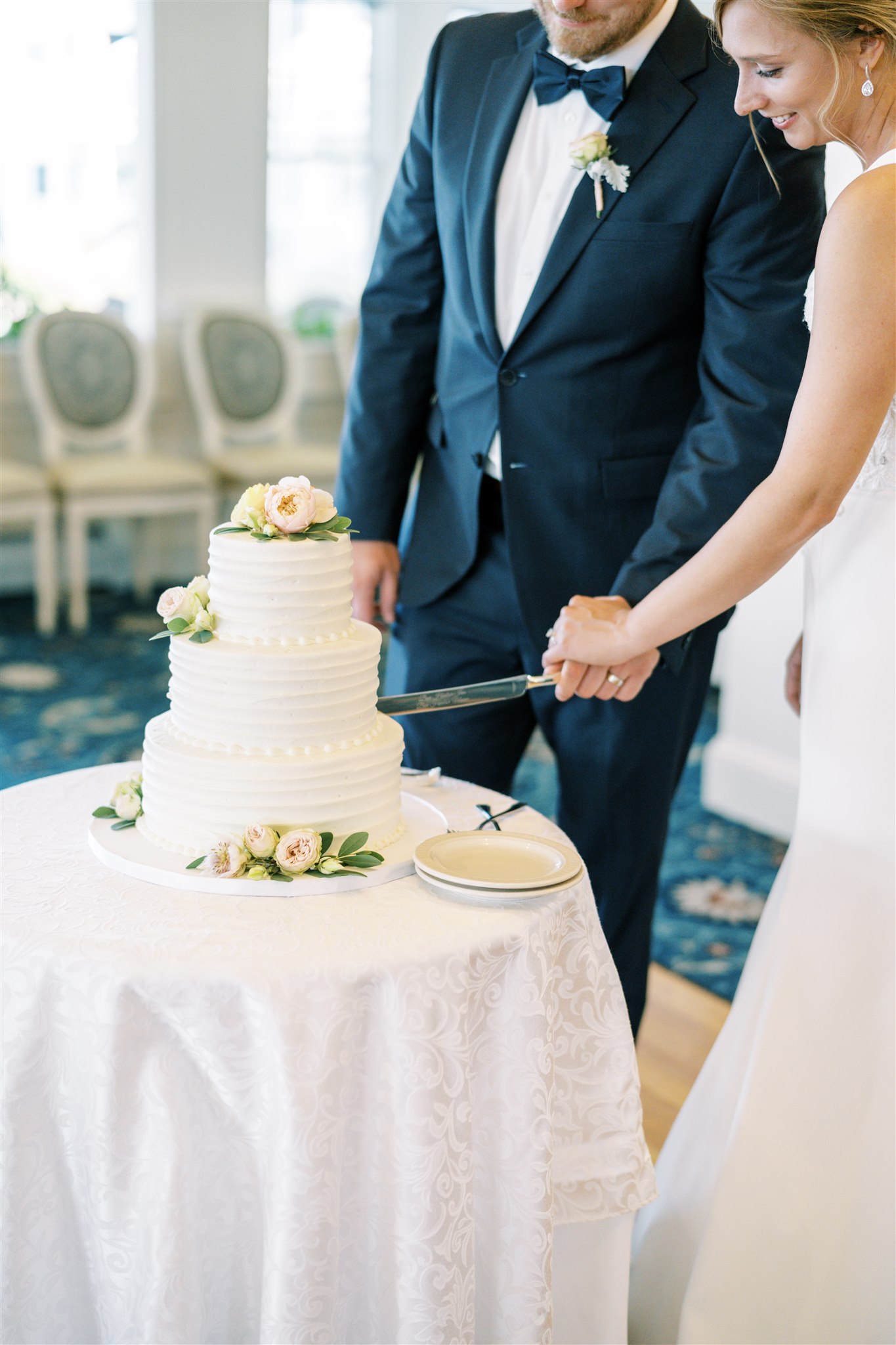 Photo of bride and groom cutting the cakeat the Bar Harbor Inn