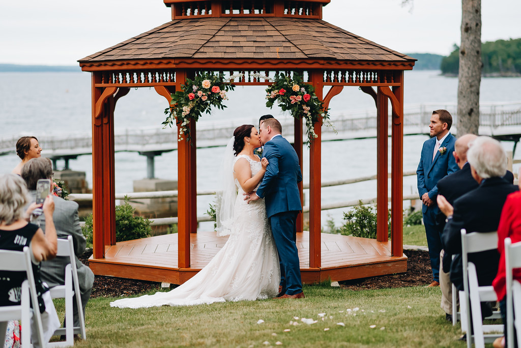 Photo of the bride and groom kissing in front of the wedding gazebo at the Atlantic Oceanside Hotel
